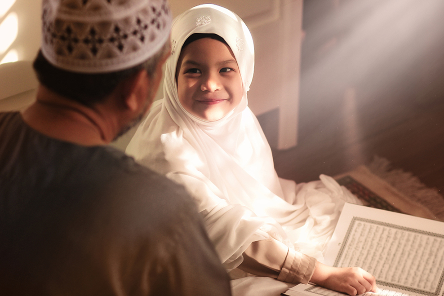 A shaikh teaching a kid the Quran with fun