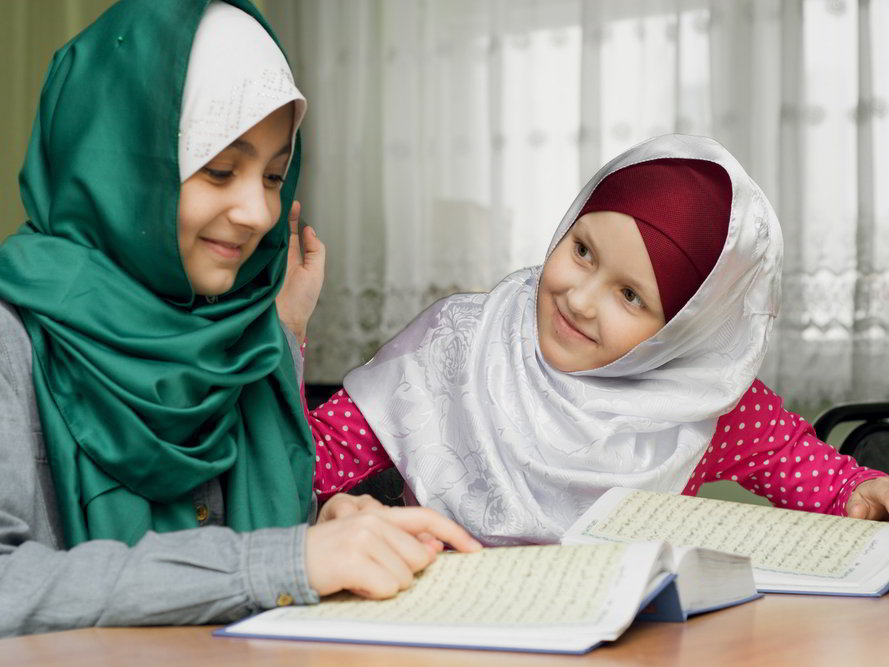 Two Muslim girls memorizing the Quran with each other