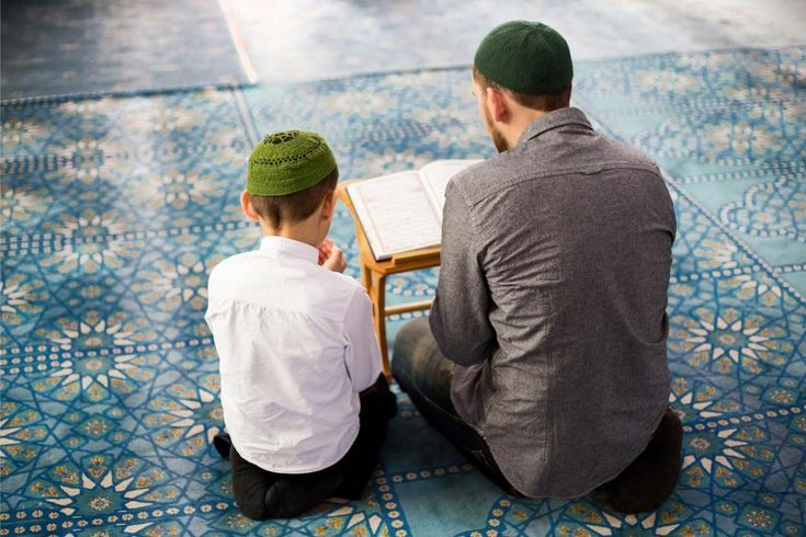 An adult teaching a child Arabic