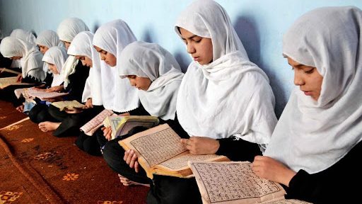 Muslim girls reading Quran in a Halaqa