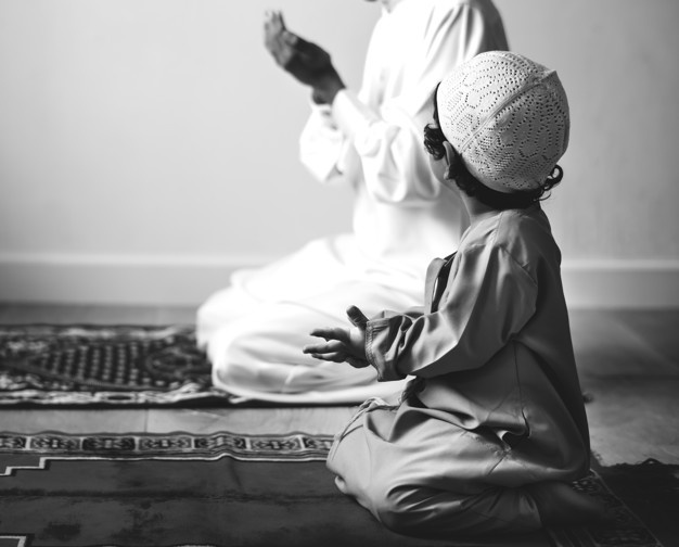 A kid learning how to pray