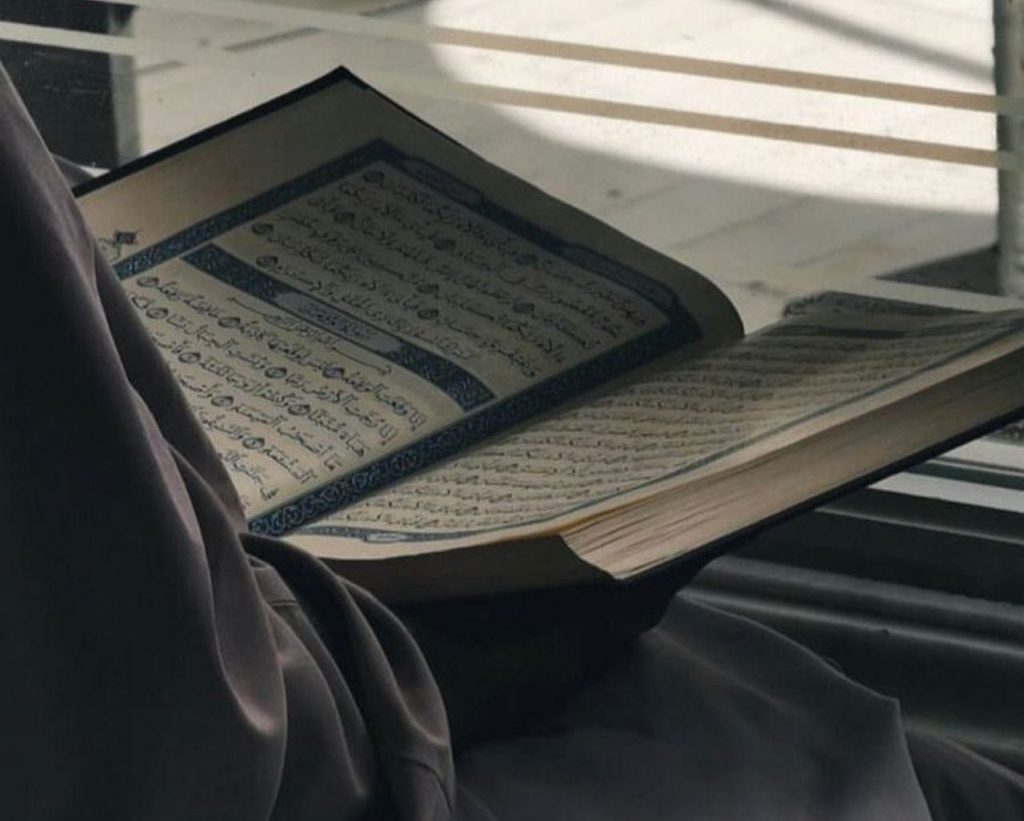 A Muslim woman reading Quran
