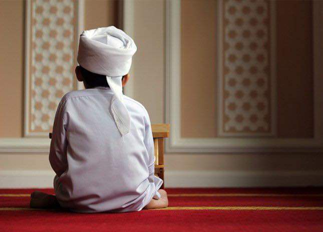 Muslim kid sitting in a Masjid