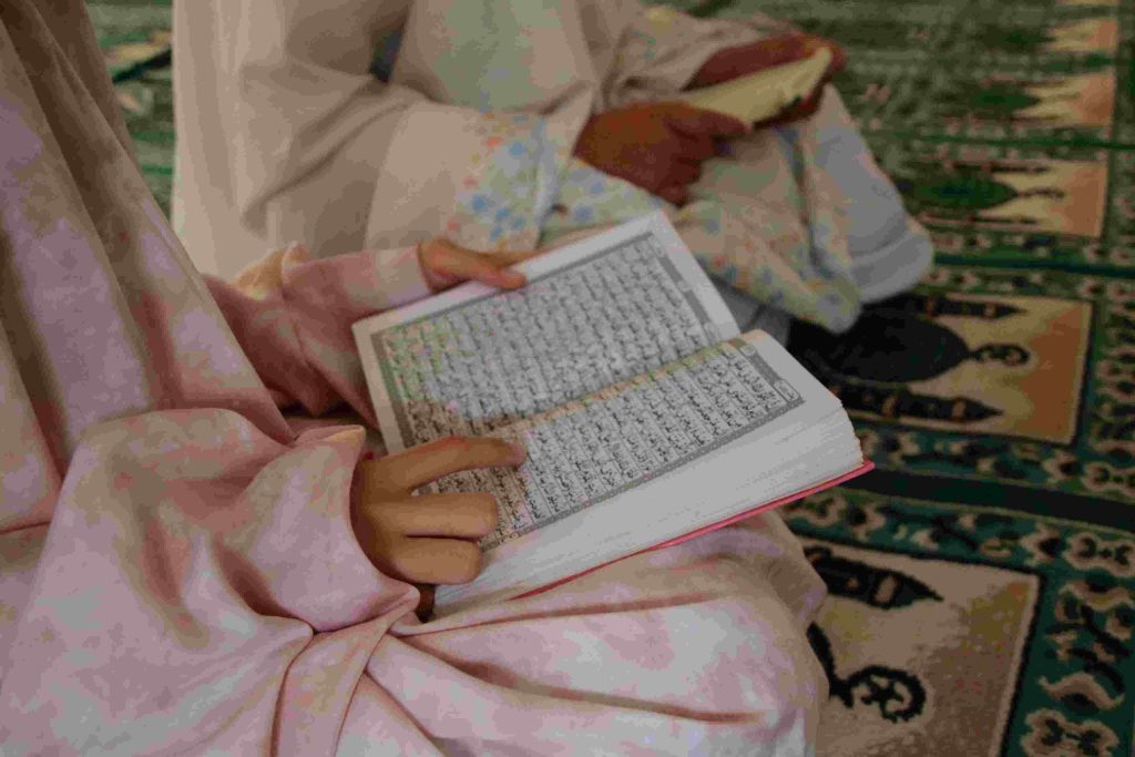 Two girls reciting the quran